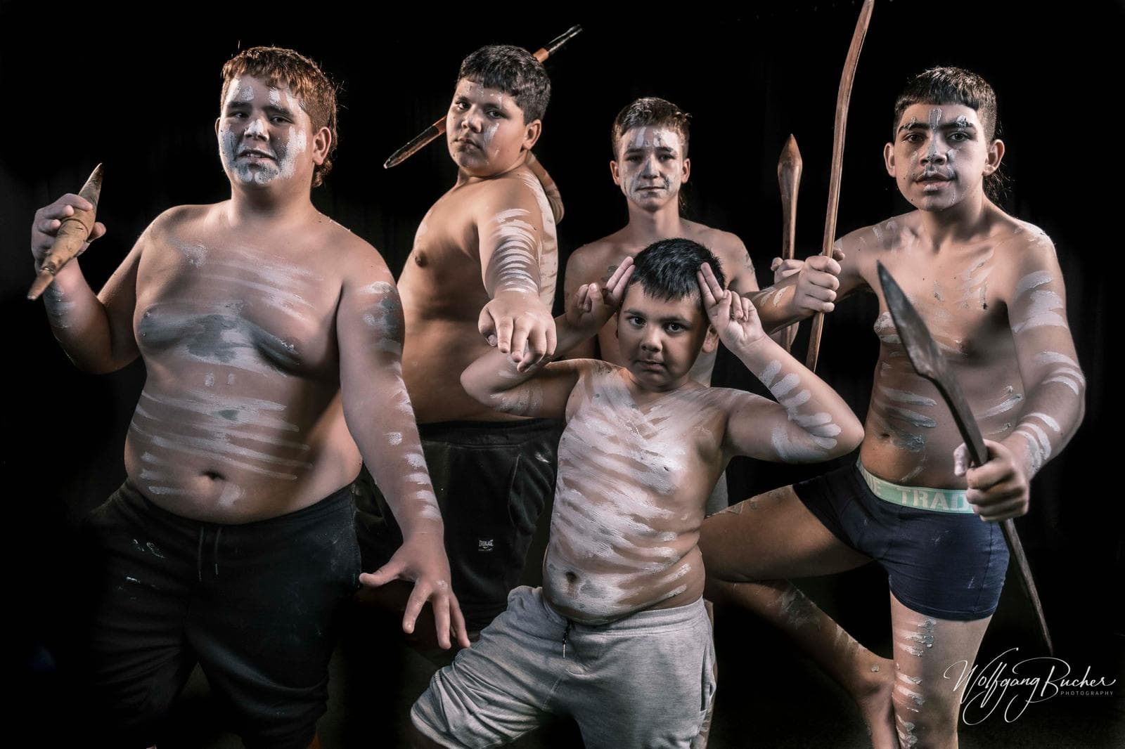 Young community members standing together in cultural body paint